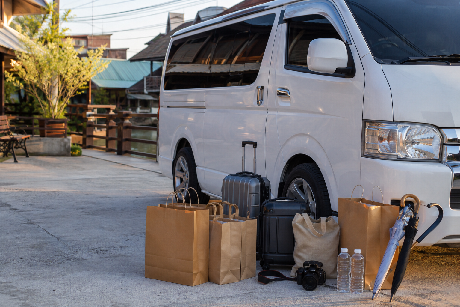 Shopping bags and umbrellas beside a private van after a market day