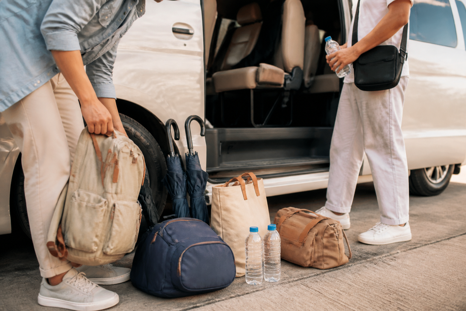 Day bags and umbrellas beside a private van after a Chachoengsao route