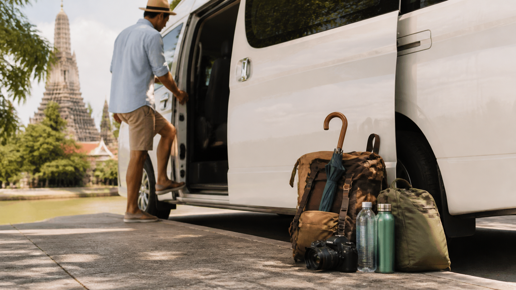 Day bags and camera gear beside a private van after a Samut Prakan route